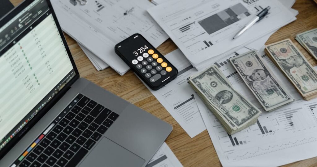 Diverse group of five colleagues smiling and collaborating around a laptop in an office